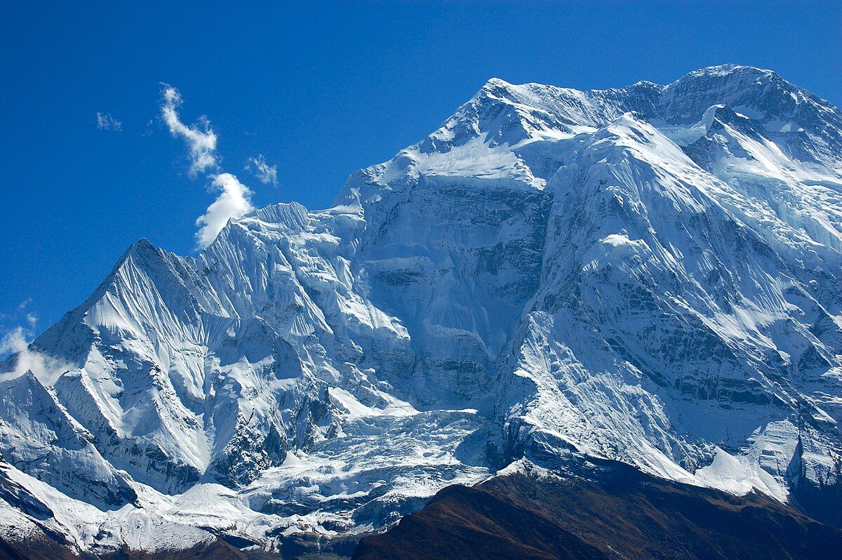 A huge wall of snow and ice under a deep blue sky